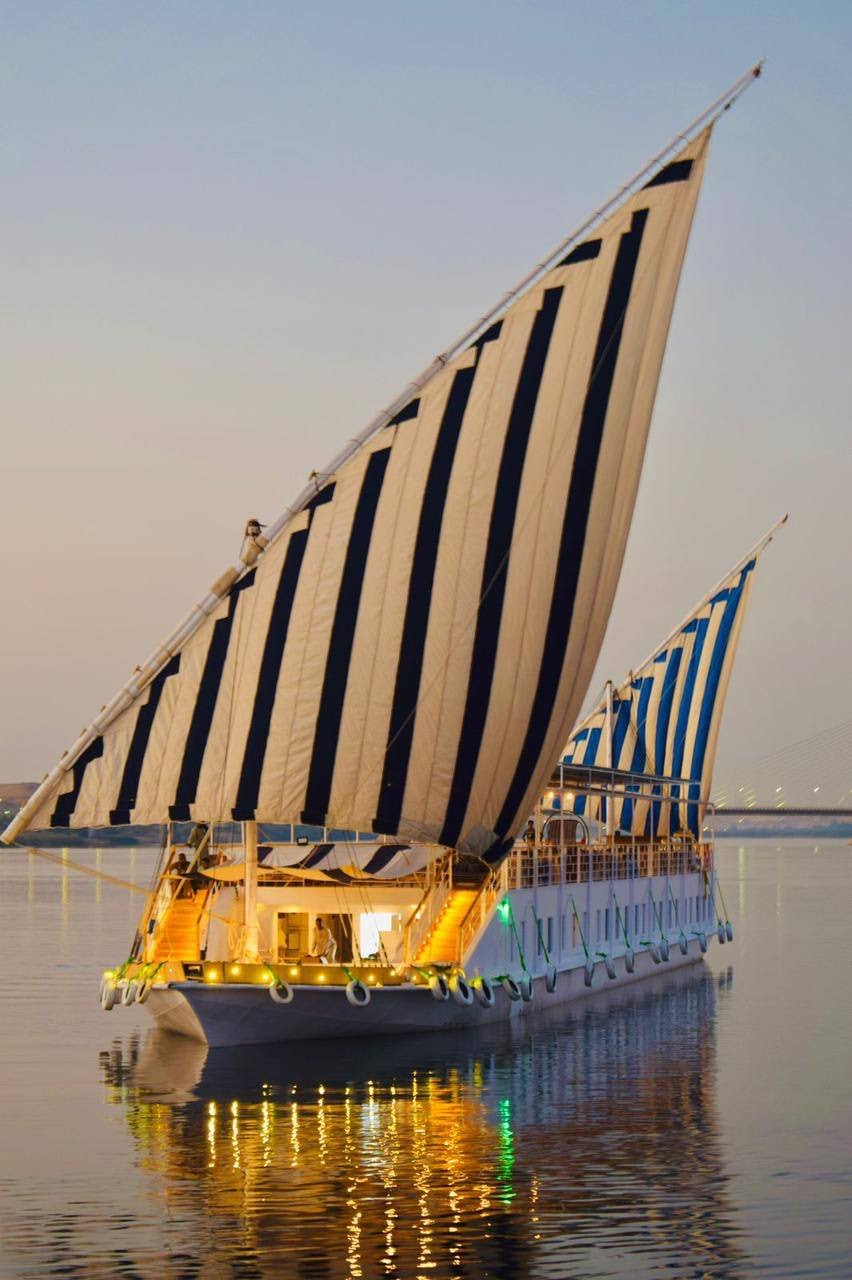 The dahabiya under full sail on the Nile at dusk