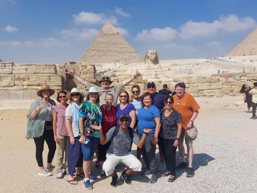The group together in front of the Pyramids and the Sphinx at Giza